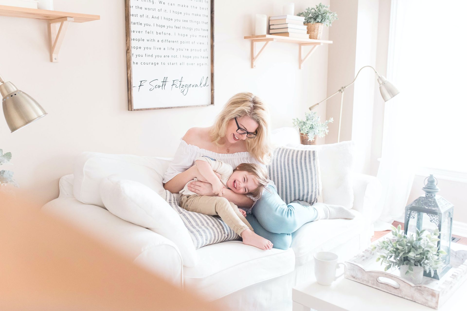 Central-Heating-Hero Mother hugging child in warm living room surrounded with comfortable furniture.