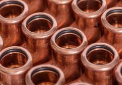 COPPERFIX copper pipe fittings equal tees close up of them all closely together and a repetitive pattern.